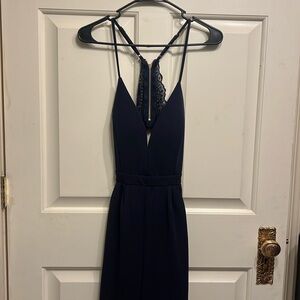 Navy blue Emerald Sundae spaghetti strap romper with lace detailing. Size M